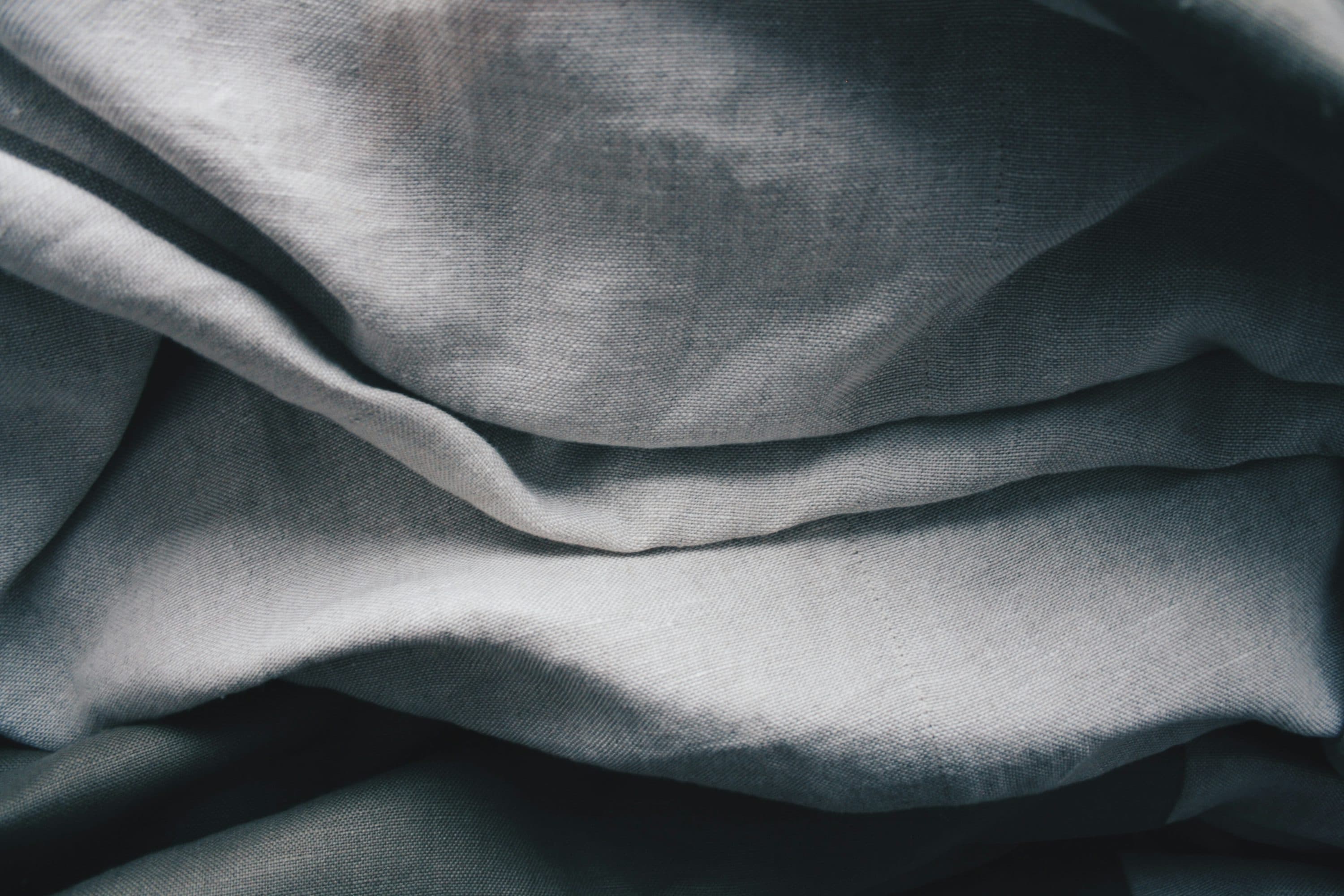 Draped grey linen fabric in soft folds