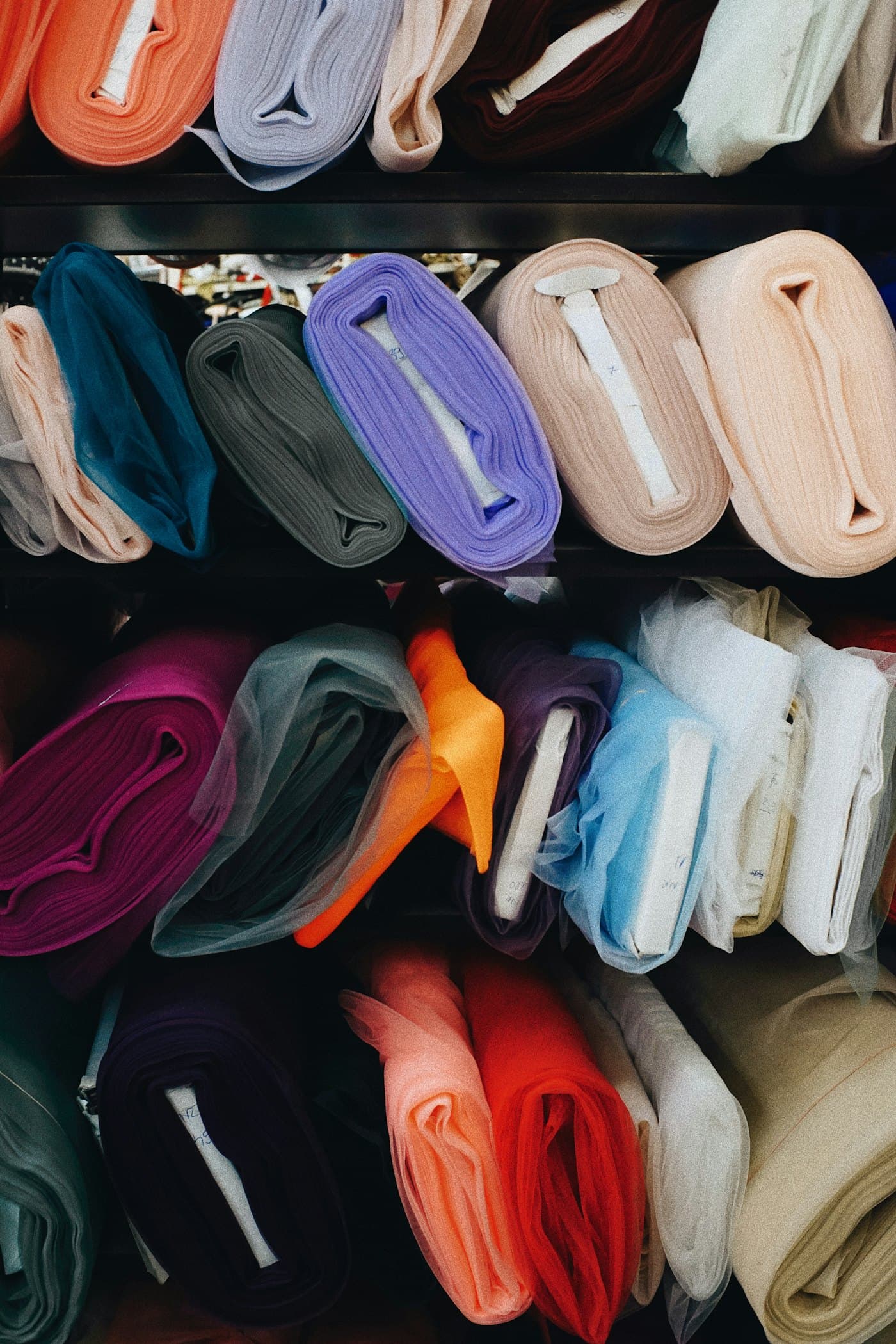 A wall of fabric rolls in many colours