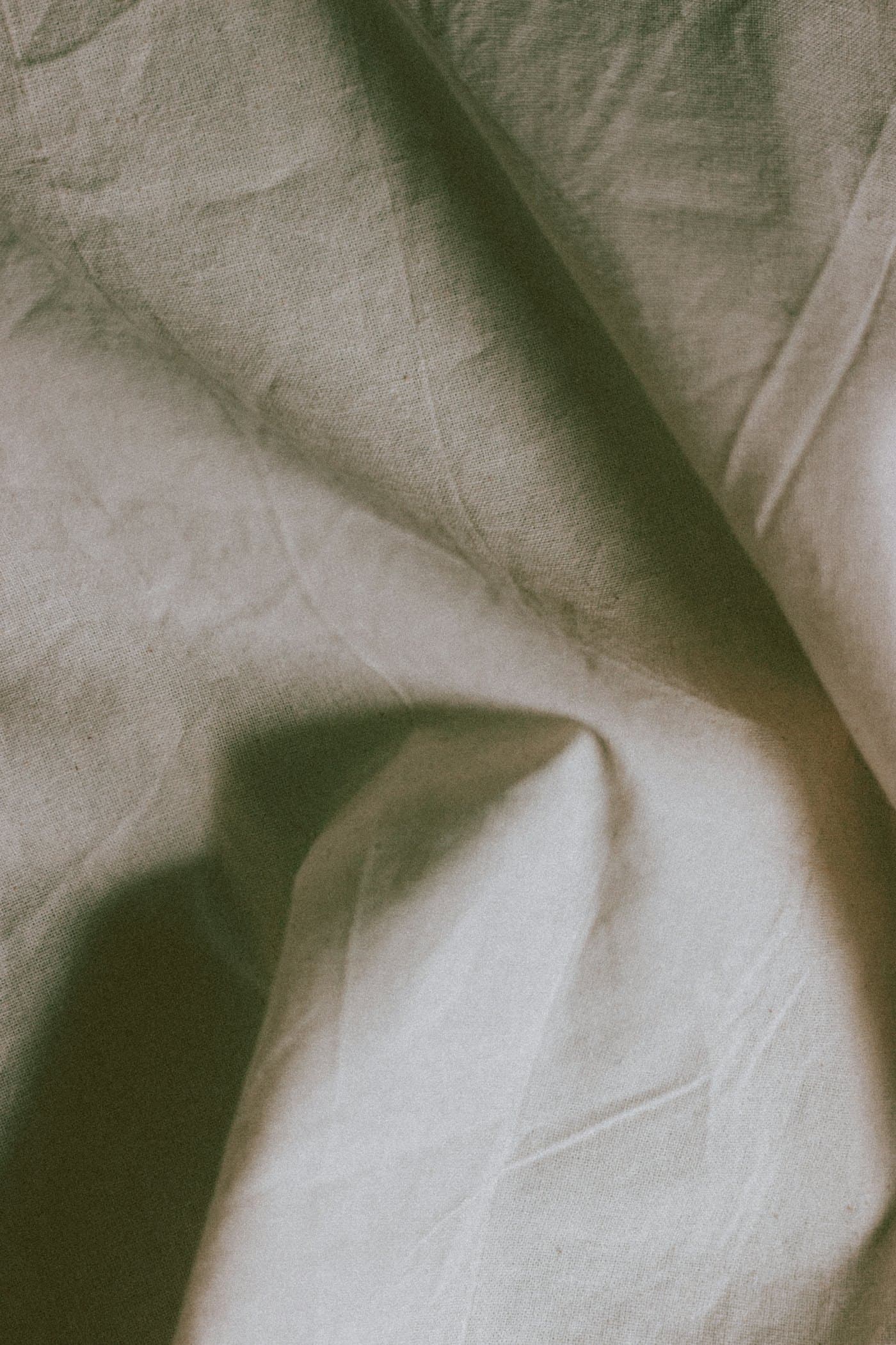 Draped natural linen catching soft light